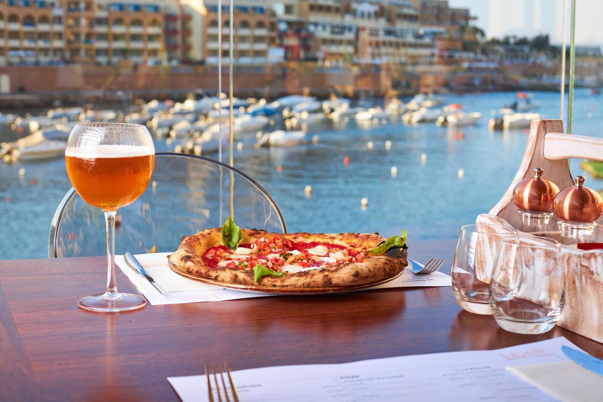 Intercontinental Malta By Ihg Hotel Saint Julian's Exterior photo A glass of beer and a pizza